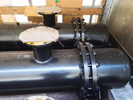 Black dusty Industrial heat exchanger, tube shell and tube high efficiency. Transportation in the truck. Wooden planks. For any purpose useの写真素材