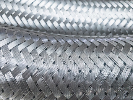 Long metal flexible compensator pipes metal texture closeup. Selective focus. White metal industrial construction.の写真素材
