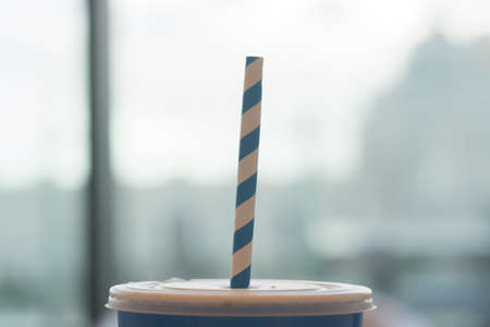 Blue and white striped organic paper straw in blue paper cup. Recycle concept.の写真素材