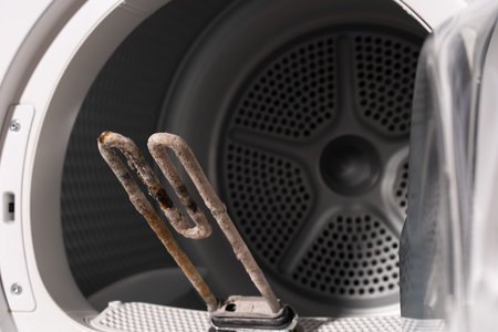 Close-Up of a Corroded Heating Element Inside a Dryer with Visible Limescale Depositsの写真素材