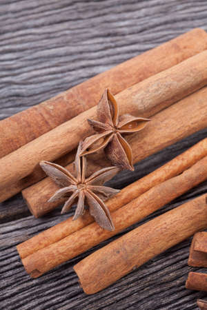 anise and cinnamon on old plank woodの写真素材
