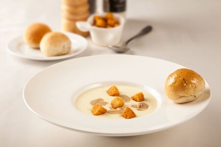 Mushroom soup with bread on the tableの写真素材