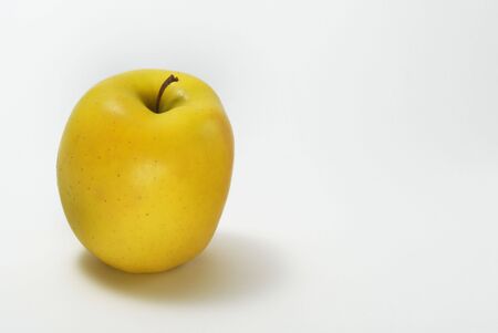 yellow apple isolated on a white backgroundの写真素材
