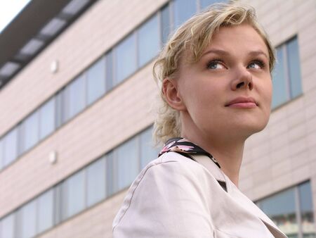 Businesswoman standing outside a modern office buildingの写真素材
