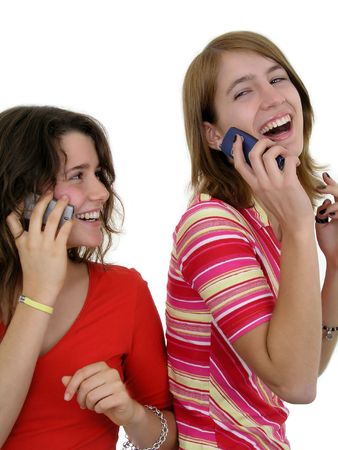 Two girls using mobile phonesの写真素材