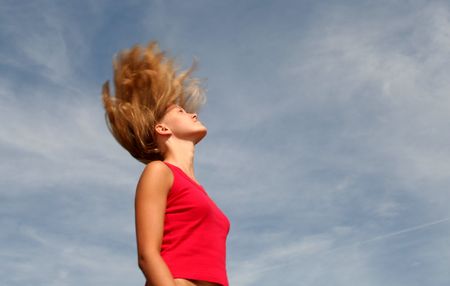 Young woman with hair flyingの写真素材