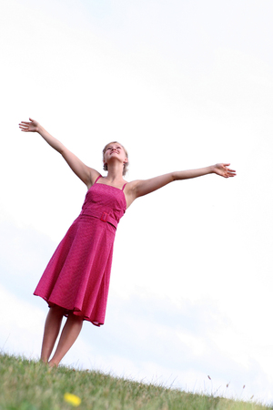 Woman standing with arms raised の写真素材