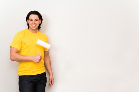 Man holding paint roller の写真素材