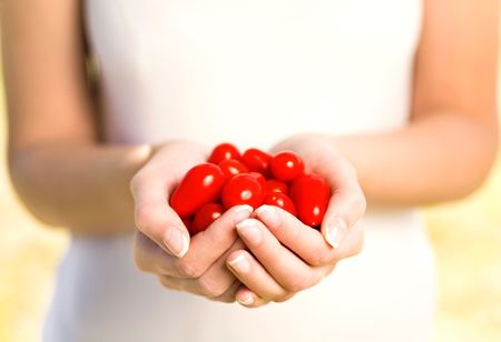 Woman holding cherry tomatoesの写真素材