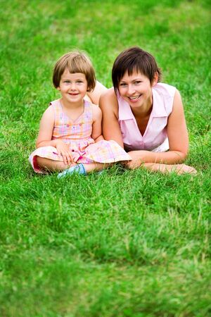 Mother and daughter on grassの写真素材
