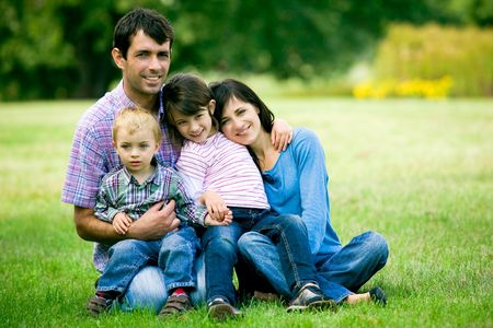 Family sitting outdoorsの写真素材