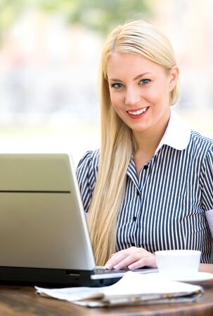 Businesswoman outdoors with laptopの写真素材