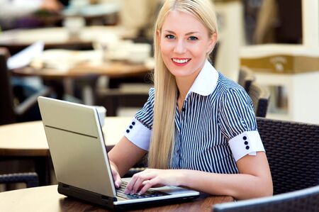 Businesswoman outdoors with laptopの写真素材