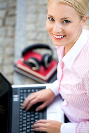 Woman using laptop outdoorsの写真素材