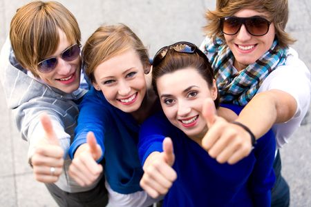 Friends showing thumbs up signの写真素材