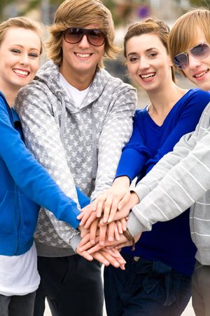 Friends putting hands togetherの写真素材