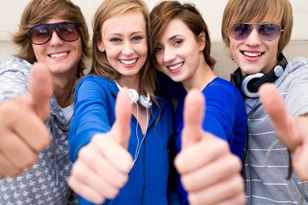 Friends with thumbs upの写真素材