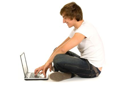 Casual guy sitting with laptopの写真素材