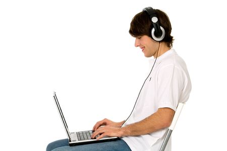 Man Sitting in Chair Using Laptopの写真素材