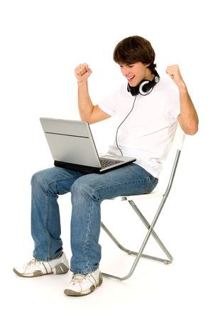 Man Sitting in Chair Using Laptopの写真素材