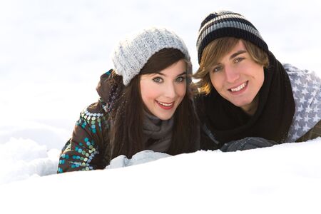 Couple lying in snowの写真素材