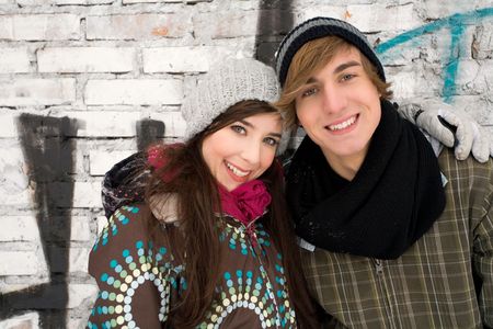 Couple standing in front of graffitiの写真素材