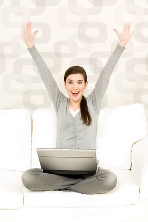 Woman cheering on couchの写真素材