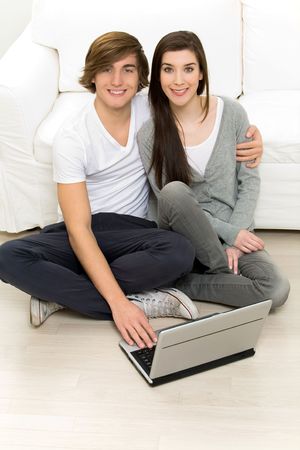 Young couple using laptop at homeの写真素材