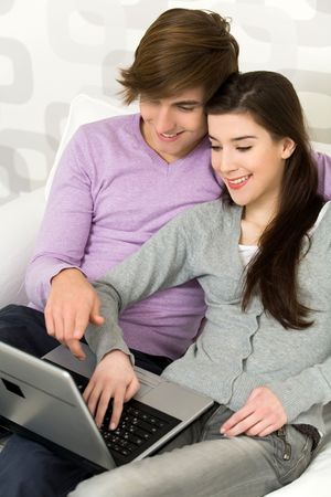 Young couple using laptopの写真素材