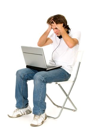 Man Sitting in Chair With Laptopの写真素材