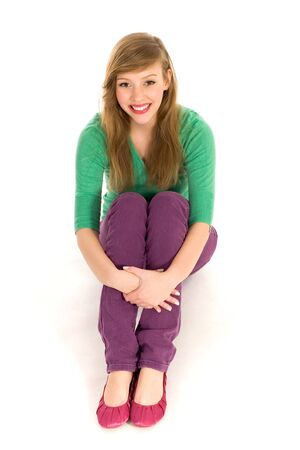 Teenage girl sitting on floorの写真素材