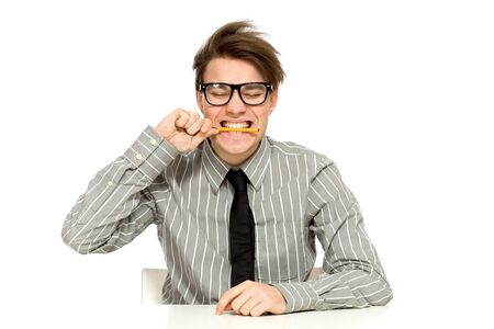Businessman biting penの写真素材