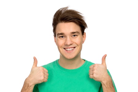 Casual young guy showing thumbs upの写真素材