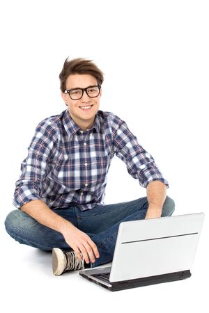 Young man sitting with laptopの写真素材