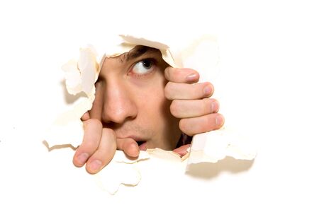 Looking through paper holeの写真素材