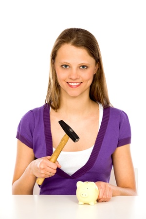 Girl with hammer and piggy bankの写真素材