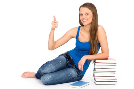 Young woman sitting with booksの写真素材