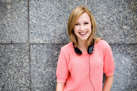 Young woman leaning against wallの写真素材