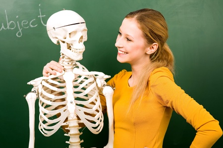Female student with skeletonの写真素材