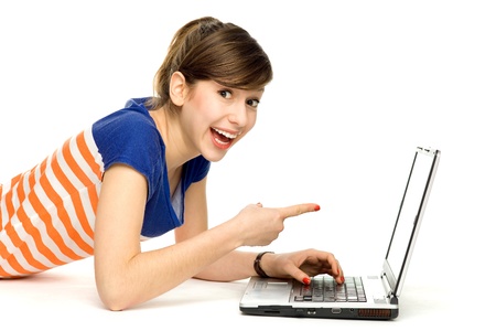 Young woman lying down with laptopの写真素材