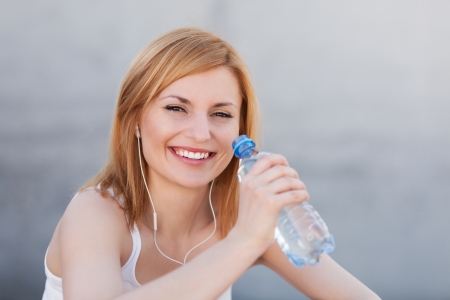Young woman holding bottle of water の写真素材