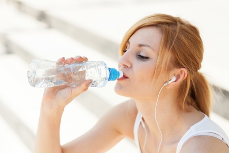 Young woman drinking waterの写真素材