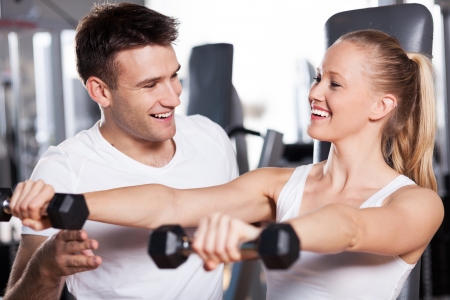 Woman exercising with personal trainerの写真素材