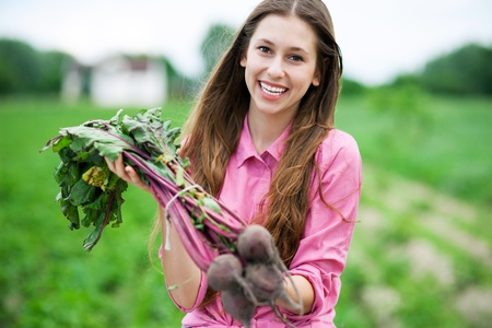 Young woman holding fresh beetsの写真素材