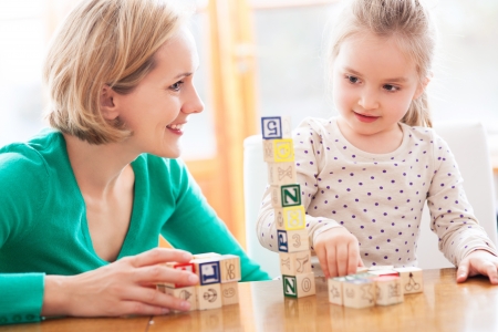 Mother and daughter playing with blocksの写真素材