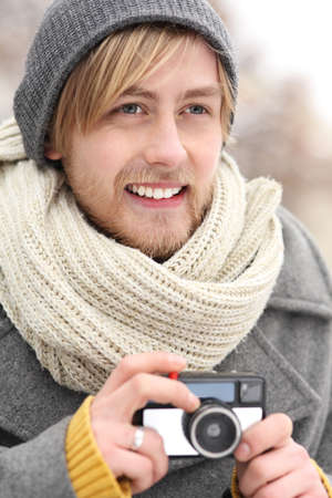 Young man with vintage cameraの写真素材