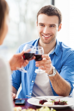 Couple having toast in restaurantの写真素材