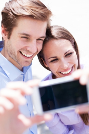 Couple taking photo of themselves の写真素材