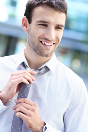 Businessman adjusting his tieの写真素材
