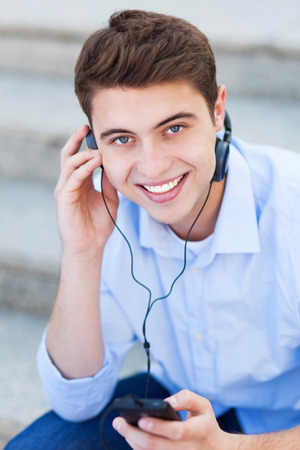 Young man listening to musicの写真素材